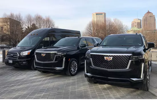 Luxury SUV and Sprinter Van With Boston Skyline